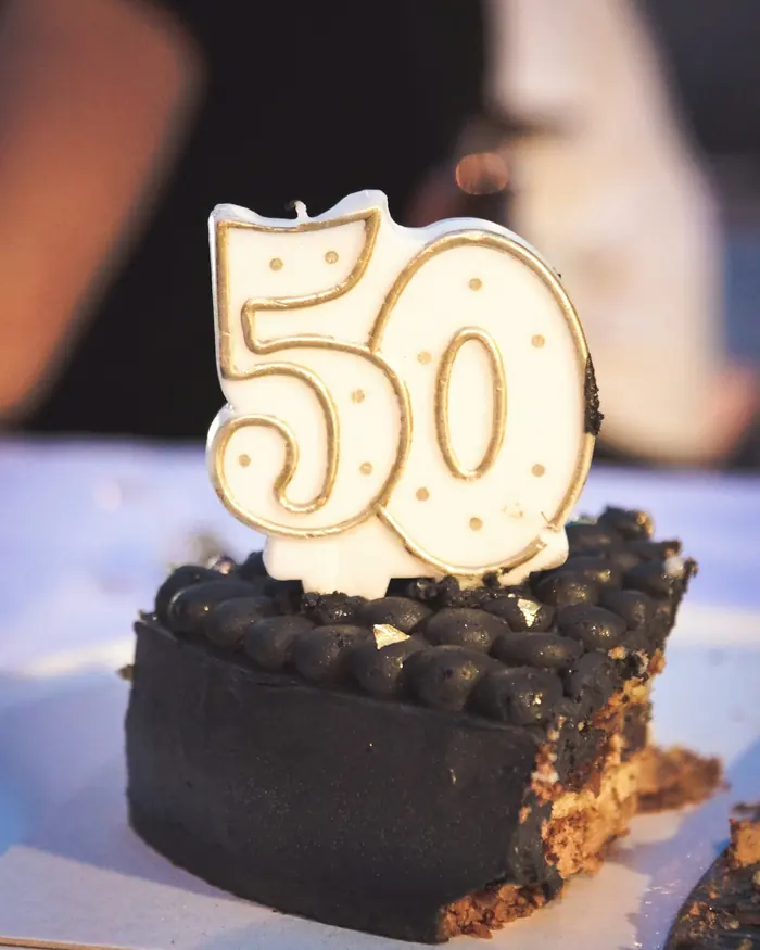 A birthday cake topped with a number 50 candle