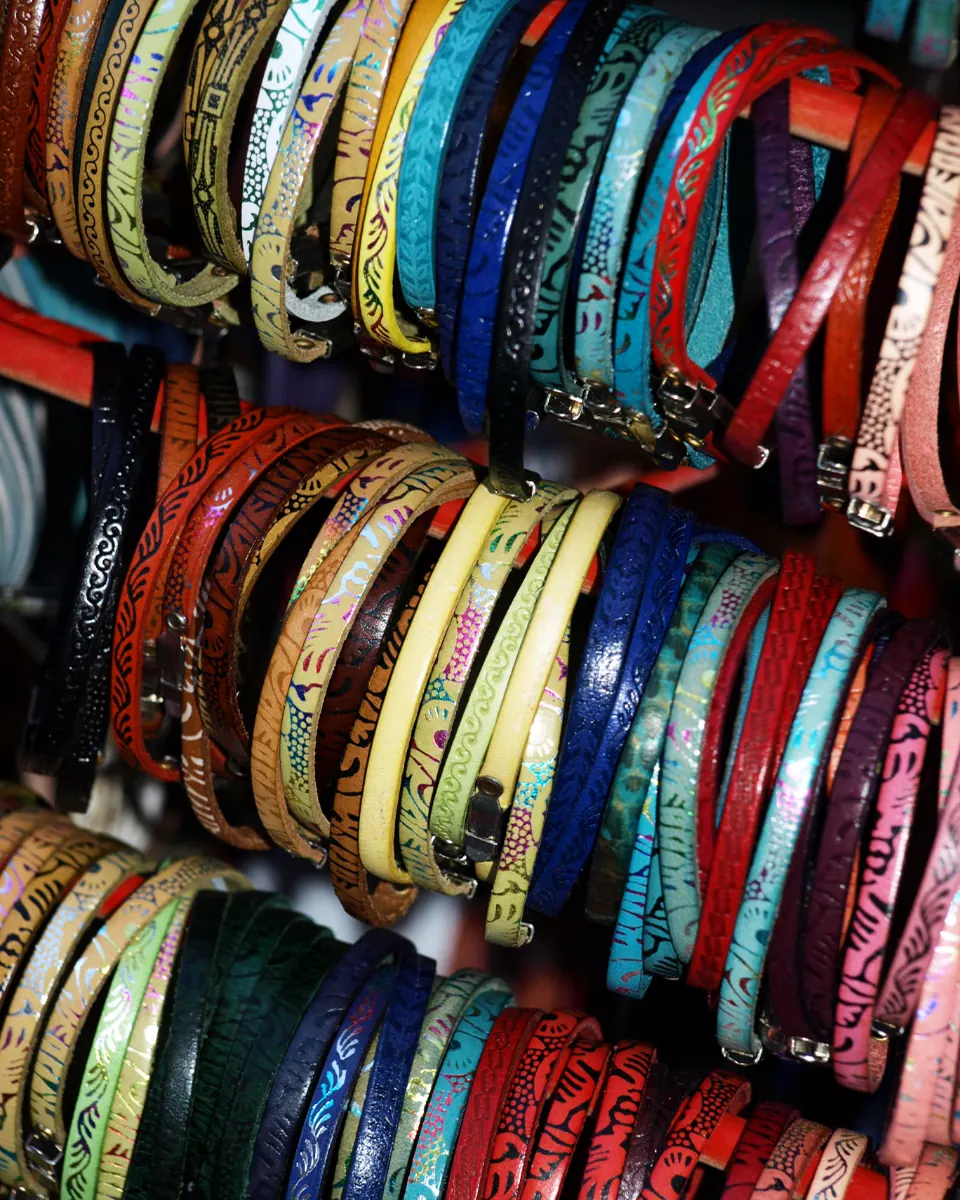 Stacks of colorful glass bangles hanging at a market stall
