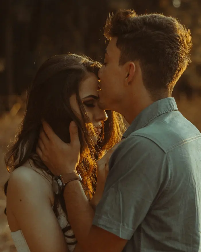 A husband kissing his wife on the forehead