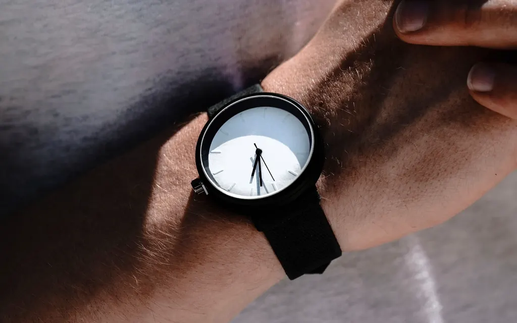 A black and white watch on a man’s wrist